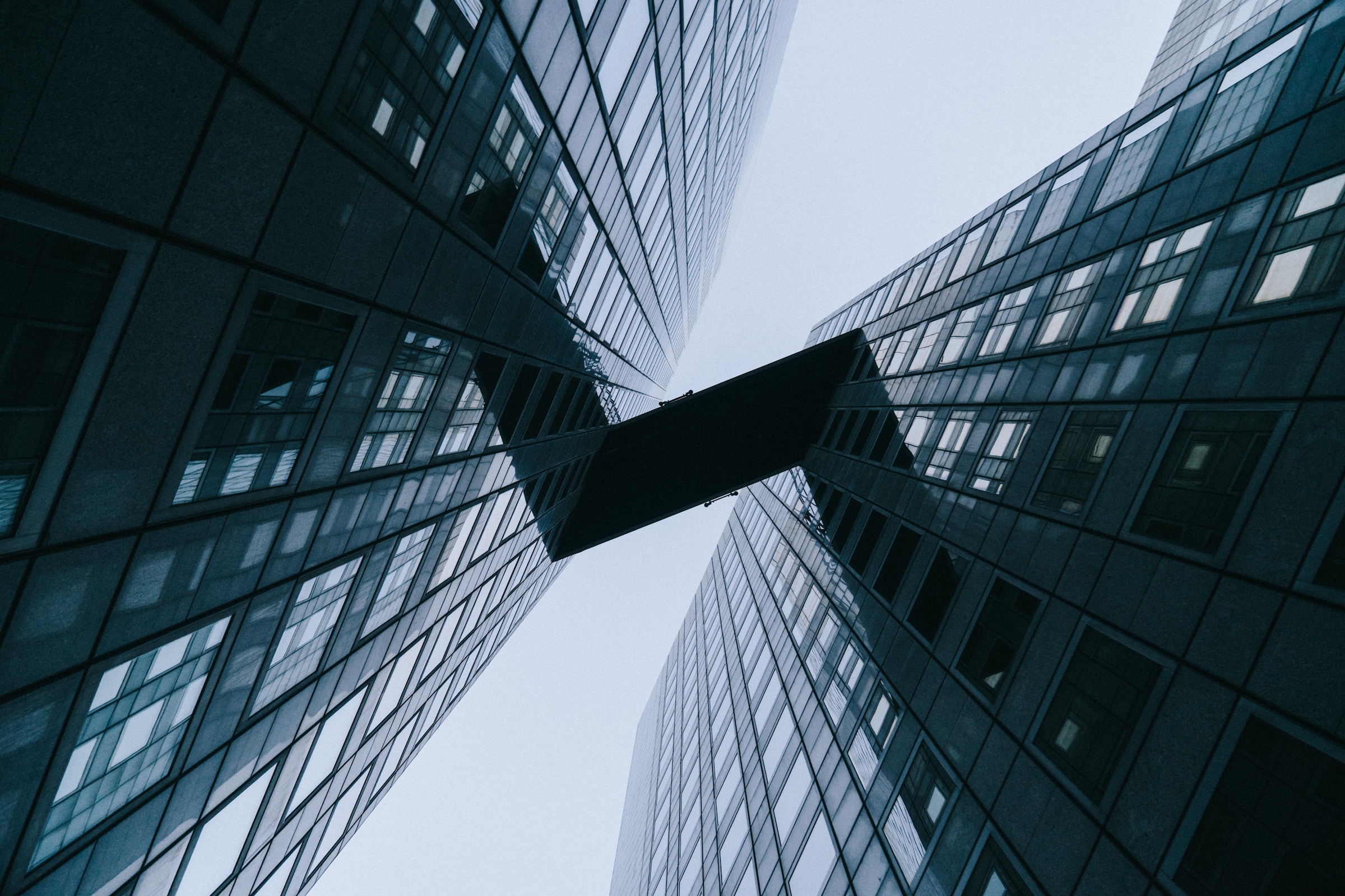 Two large skyscrapers connected by a bridge, symbolising the interconnectedness and partnership in the world of social media engagement.